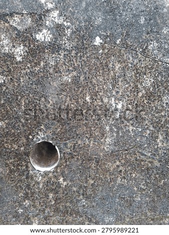 Close-up view of a retaining wall featuring a PVC drainage pipe (weep hole) designed to release trapped groundwater and reduce hydrostatic pressure behind the structure. This essential civil engineering component helps prevent wall cracking, soil failure, structural instability, and landslides. The image highlights drainage infrastructure, geotechnical engineering, retaining wall construction, and water management systems in modern civil works.