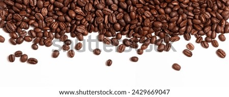 A close-up view of rich, aromatic coffee beans isolated against a clean, white background. The beans are varying shades of brown and have a shiny, oily appearance, hinting at the delicious aroma