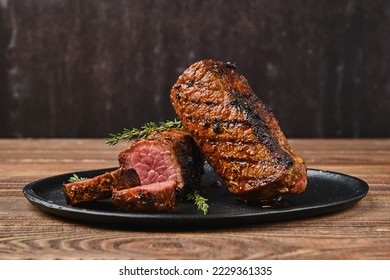 Closeup view of roasted beef brisket flat steak on a plate
