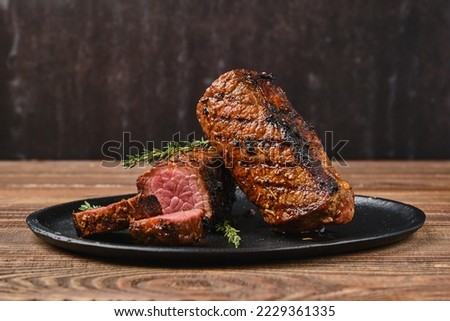Closeup view of roasted beef brisket flat steak on a plate