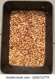 Close-up View Of Roasted Peanuts In A Roasting Tin.