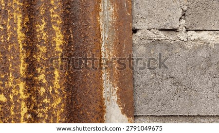 Close-up view of a rough cement wall texture combined with a weathered rusty corrugated metal sheet. The industrial surface features natural wear, corrosion patterns, stains, and aged materials that create a strong urban and industrial character. Ideal for design backgrounds, grunge textures, construction themes, industrial concepts, architectural details, graphic design resources, and creative visual projects