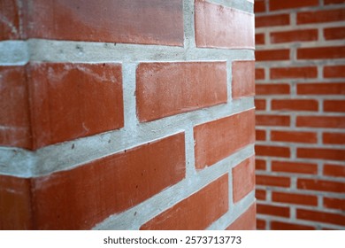 A close-up view of rustic red bricks showcases their unique textures and colors.