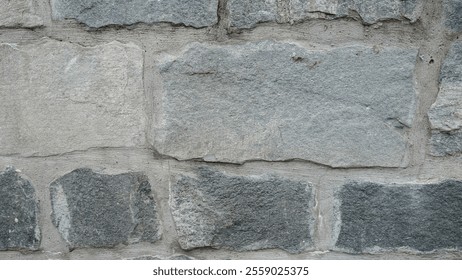 Close-up view of a rustic stone wall showcasing natural textures and neutral colors.