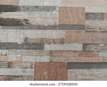 A close-up view of a rustic wall made from various wooden planks, showcasing different shades, textures, and natural imperfections, creating a unique and weathered background.