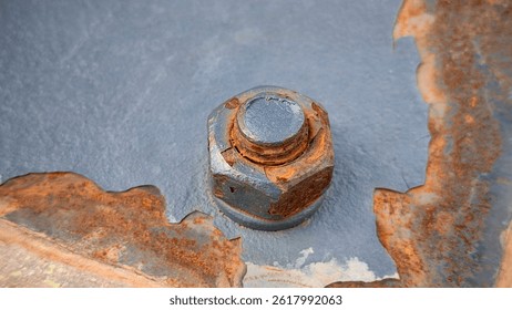 Close-Up View of a Rusty Bolt and Nut on Painted Metal Surface