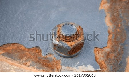 Close-Up View of a Rusty Bolt and Nut on Painted Metal Surface