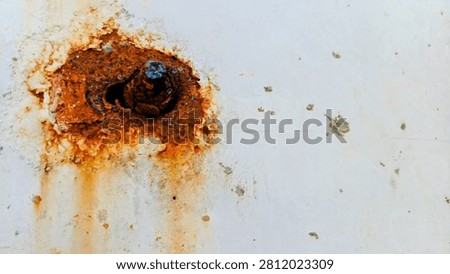 Close-Up View of a Rusty Bolt and Nut on Painted Metal Surface
