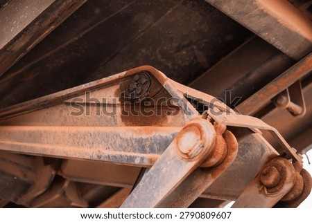 A close-up view of rusty machinery components highlights engineering intricacies in an industrial environment.
