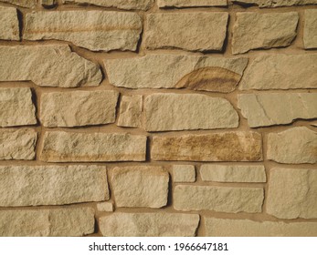 Closeup View Of Sand Stone Rock Wall With Colored Grout Matching With Shadows And Details