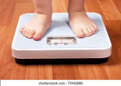 Closeup view of scales on a floor and kids feet