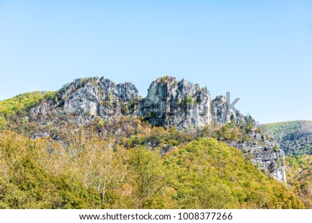 Closeup up view of Seneca Rocks during autumn, golden yellow foliage on trees, forest