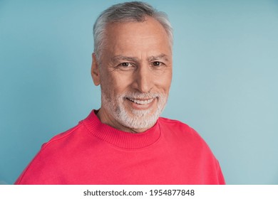 Close-up view, senior man smiling on blue background. Attractive man in a bright pullover. - Powered by Shutterstock