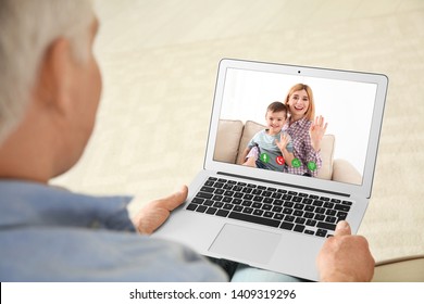 Closeup View Of Senior Man Talking With Family Members Via Video Chat At Home 