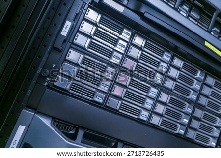 A close-up view of a server rack displaying multiple storage units, showcasing modern technology and infrastructure essential for data management and connectivity.