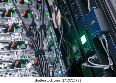 Close-up view of server rack highlighting network equipment, cables, and monitoring devices in a data center, showcasing technology and organization in modern infrastructure.