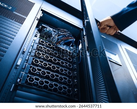 A close-up view of a server rack in a modern data center, showcasing neatly organized cables and advanced hardware, representing high-performance technology.