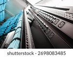 A close-up view of a server rack showcasing power supply units and organized cables, highlighting efficiency and management in a modern data center environment.