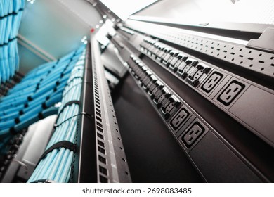 A close-up view of a server rack showcasing power supply units and organized cables, highlighting efficiency and management in a modern data center environment.