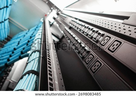 A close-up view of a server rack showcasing power supply units and organized cables, highlighting efficiency and management in a modern data center environment.