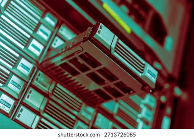Close-up view of a server storage device being removed from a rack in a data center, showcasing advanced technology for efficient data management and storage solutions.