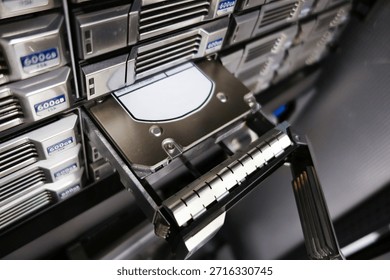 Vista de cerca de un sistema de almacenamiento de servidor que muestra una herramienta de eliminación de disco duro. Esta configuración de alta tecnología enfatiza la importancia de la gestión de datos y los procesos de recuperación en los entornos informáticos modernos.