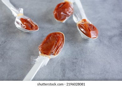 A Closeup View Of Several Tamarind Candy Spoons.