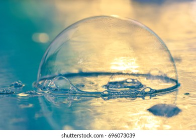 Close-up View Of A Single Soap Bubble On Shimmering Background