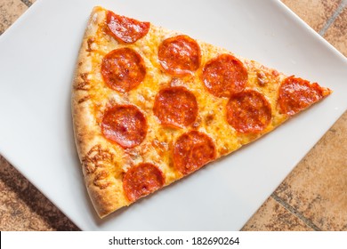 Closeup view of a slice of a pepperoni pizza