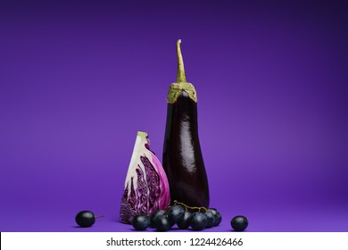 close-up view of sliced cabbage, grapes and eggplant on purple