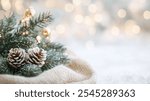 A close-up view of soft Christmas decorations featuring pinecones nestled in greenery, with a delicate bokeh background, creating a warm festive ambiance.