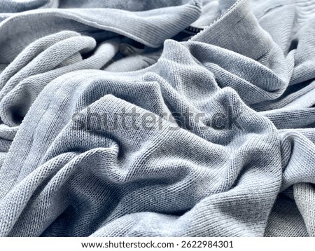 Close-up View of Soft Gray Knitted Fabric with Detailed Texture