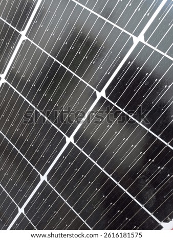 Close-up view of a solar panel showing the intricate design of photovoltaic cells, reflecting sunlight and symbolizing clean, renewable energy solutions.