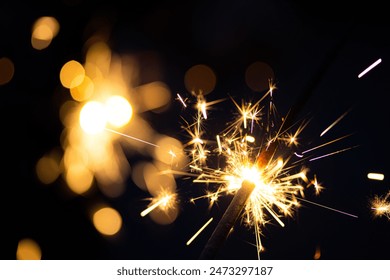 close-up view of a sparkler burning brightly against a dark background - Powered by Shutterstock