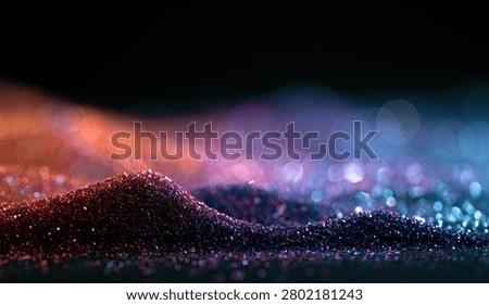 A close-up view of sparkling glitter creating a textured landscape with soft bokeh lights in a gradient of orange, pink, and blue.