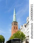 Close-up view of spire steeple of St Jakobi gothic church with clocks in old Lubeck town center. UNESCO heritage city altstatd in Germany travel destination