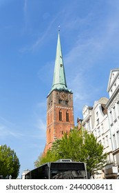 Close-up view of spire steeple of St Jakobi gothic church with clocks in old Lubeck town center. UNESCO heritage city altstatd in Germany travel destination