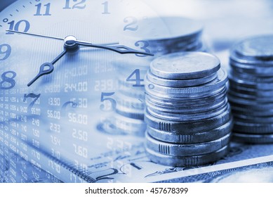 Closeup view : Stack of coins and a clock hands. A concept / idea of time value of money. Money at present time is worth more than the same amount in the future due to its potential earning capacity.