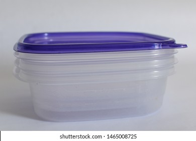 Closeup View Of Stacked Clear Tupperware With Blue Lid Isolated On White Background