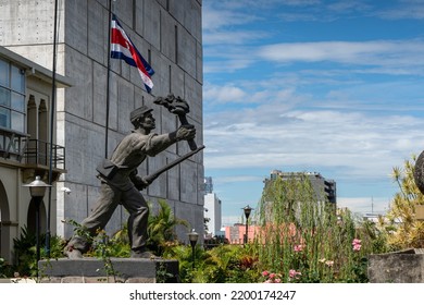 Closeup view of the statue -monument of the national hero  Juan Santamaria- next to the Costa Rica Flag - Shutterstock ID 2200174247