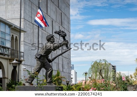 Closeup view of the statue -monument of the national hero  Juan Santamaria- next to the Costa Rica Flag