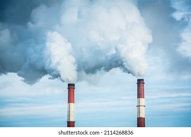 Closeup view steam coming out of pipes of thermoelectric power station in winter time.Termal power industry and environmental pollution concept and .