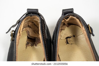 Close-up View Stock Photography Of Damaged Old Worn Torn Black Female Leather Shoes With Holes And Scratches Standing On White Background