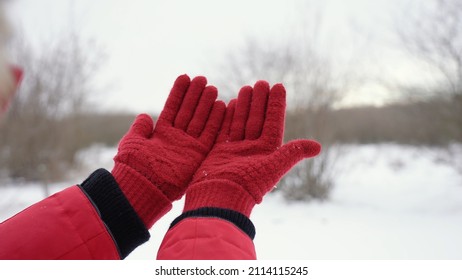 Closeup View Stock Photography Of Two Female Hands In Red Gloves Isolated On White Snow Background. Woman Holding Both Empty Palms Making Cupped Gesture With Her Outstretched Arms 