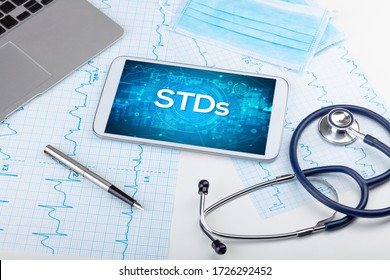 Close-up view of a tablet pc with STDs abbreviation, medical concept