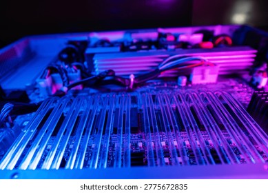 Close-up view of a technology circuit featuring vibrant neon lights. The intricate arrangement of wires and components showcases modern electronics and design.