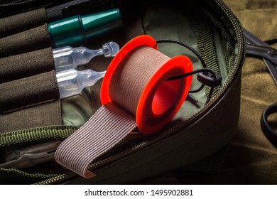 Closeup View Of Textile Medical Tape Roll In Pocket Military First Aid Kit. First Aid In An Emergency