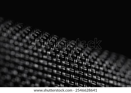 Close-up view of the texture black weave fiber. The intricate weave pattern creates a strong and lightweight structure. Abstract backround, wallpaper