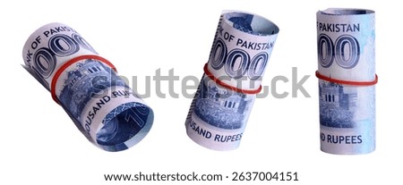 Close-up view of three rolls of one thousand Pakistani rupees banknotes tightly bound with red rubber bands against a clean white backdrop.