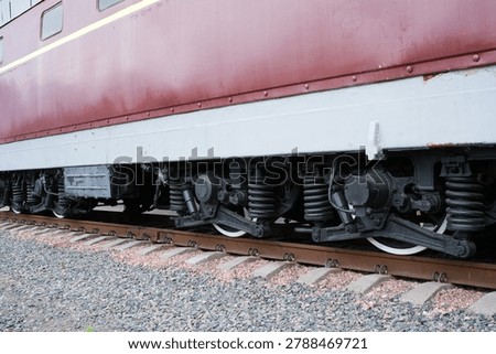 Close-up view of train wheels on tracks, highlighting the suspension system details.